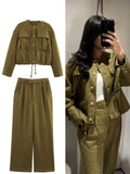 Green outfit with jacket and pants on a white background, featuring the brand 'Trafza'.